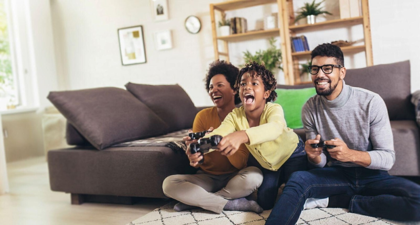 Fidium Fiber Family playing video games together on a couch at home
